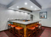 Thumbnail 11 of 26 - Community room kitchen with U shaped table and seating