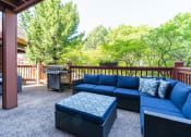 Thumbnail 14 of 26 - Outdoor patio with blue chairs and a grill