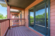 Thumbnail 19 of 27 - Maroon colored wooden deck and a sliding glass door