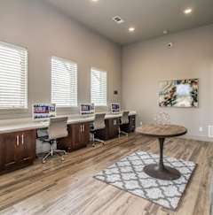 A room with wooden floors and a large table in the center.