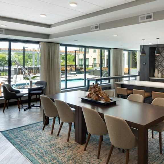 A modern dining room with a large table and chairs.