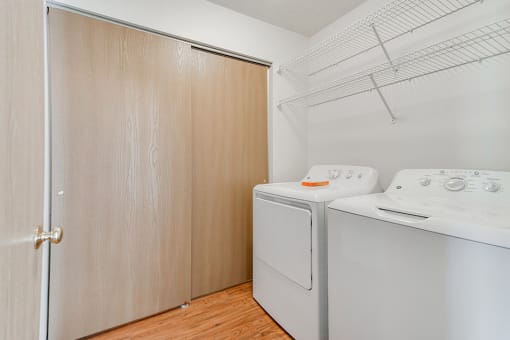 laundry room with tan sliding closet doors