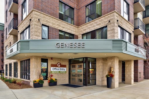 outside of entrance to apartment, with sign that says "Genesee"