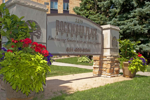 Property sign that reads "Rockwood Place Apartments" and then a phone number