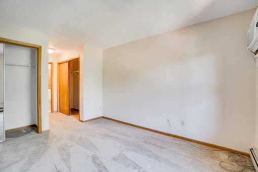 Empty bedroom with white carpet and walls