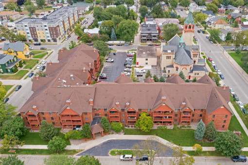 Aerial drone shot of property, with nearby buildings in view