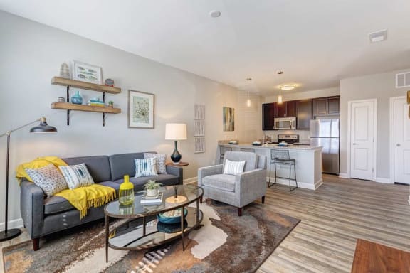 a living room and kitchen with a couch and a table