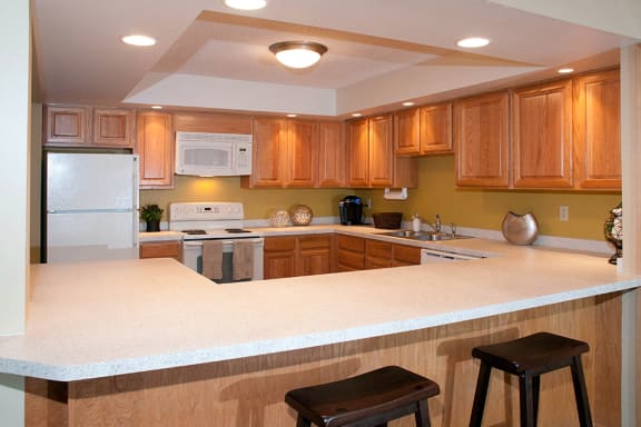 Community kitchen with appliances and C-shaped table