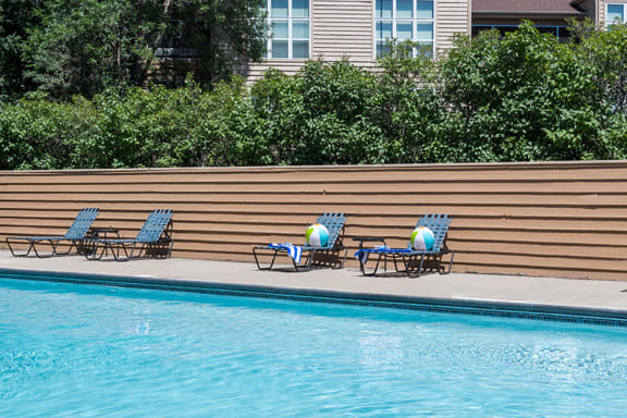 poolside lounge chairs on a sunny day
