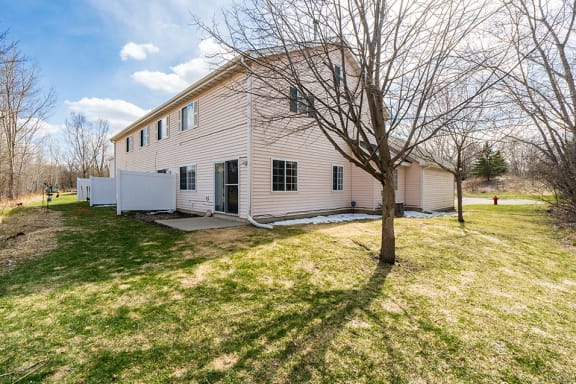 sunny outdoor shot of white townhome