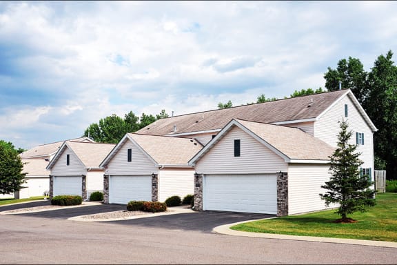 three white garages attached to townhome