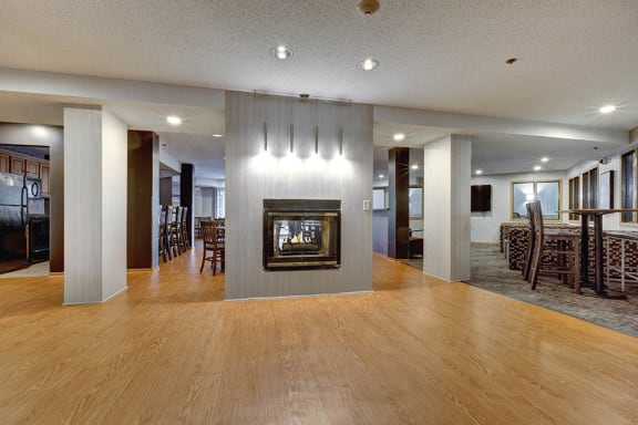 Community room with large hardwood floor and a fireplace