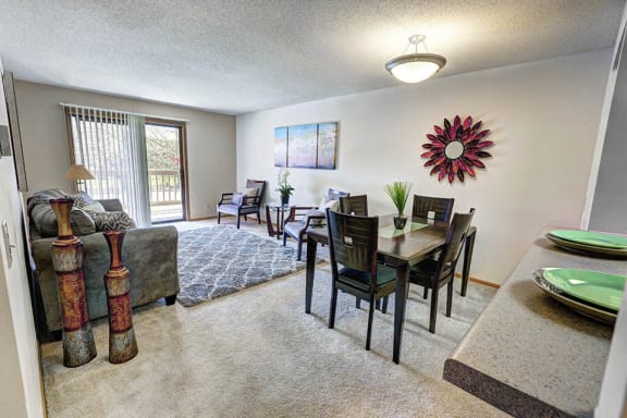 Dining and living room with a couch, chairs, and a dining table