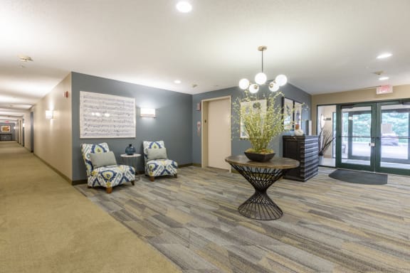 Lobby with seating and a plant on an artistic table