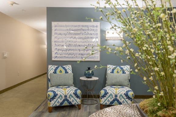 Apartment entryway with seating, artwork, and a large plant