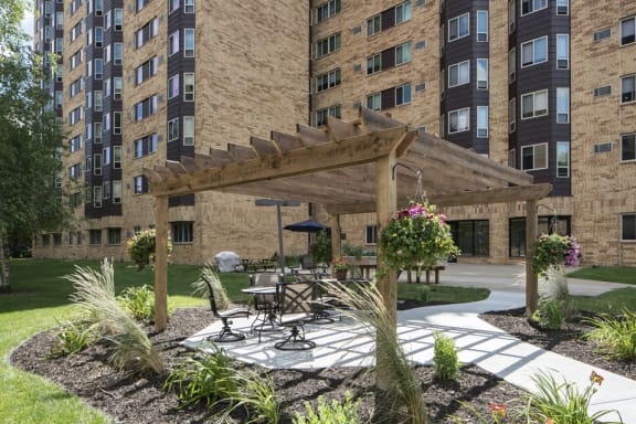 Outdoor sun terrace over patio seating, surrounded by mulch and potted plants