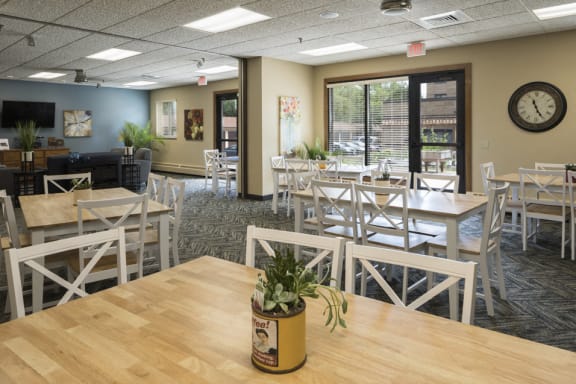 Community room with wooden tables and chairs