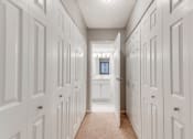 Thumbnail 8 of 25 - In between two rows of closets with a bathroom at the end of the hall