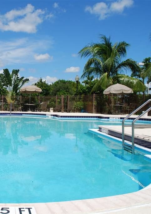 Pool with lounge chairs at Eagle Pointe, Pompano Beach at Eagle Pointe, Pompano Beach, FL