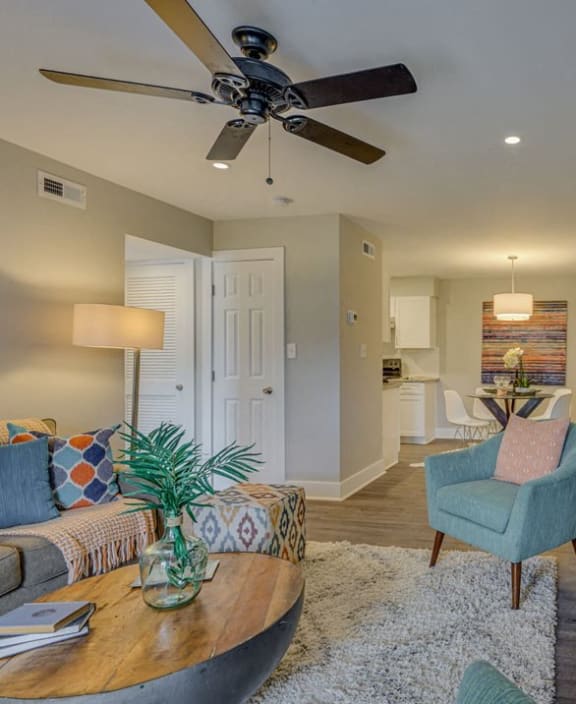 a living room with a couch and a ceiling fan