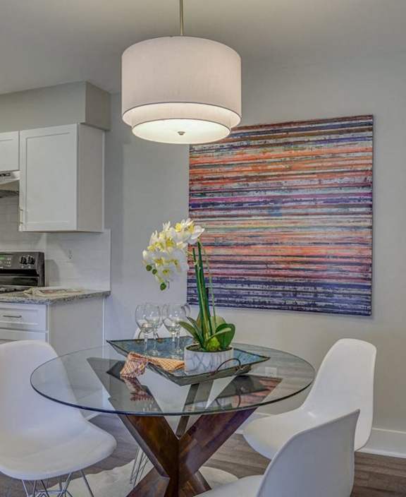 a kitchen and dining room with a glass table and chairs