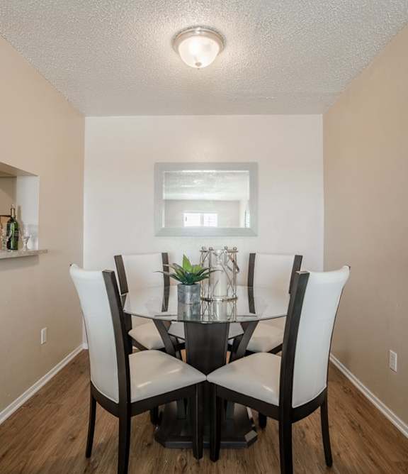 A dining room with a table and chairs.