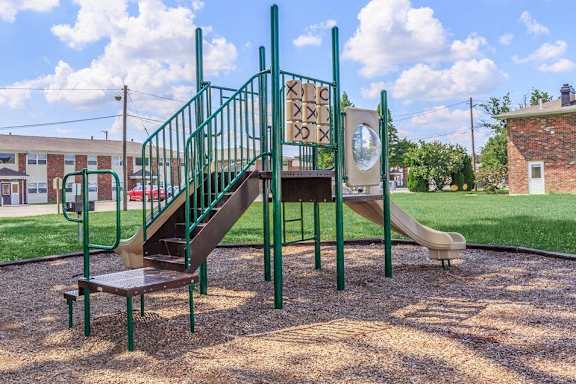 a playground with a slide and stairs in a park