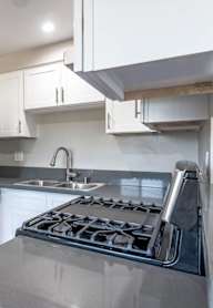 a kitchen with stainless steel appliances and white cabinets at Citrus Court Apartments, Whittier, CA, 90606