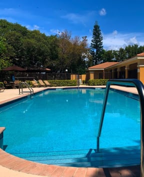 Pool with lounge chairs at Hibiscus Pointe, Florida