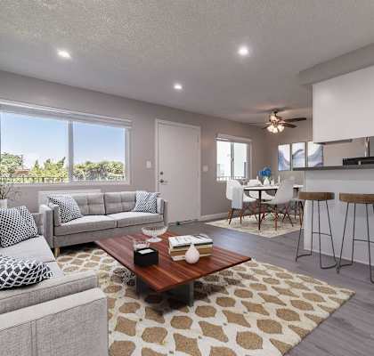 a living room with a couch and a table at Citrus Court Apartments, Whittier, CA