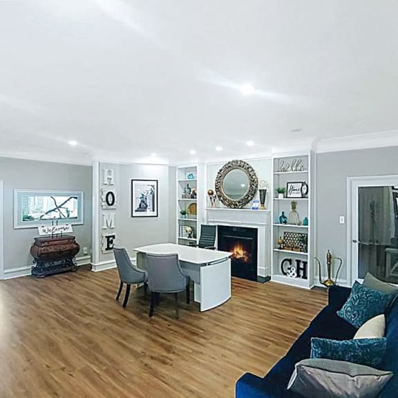 a living room with a couch and a table and a fireplace