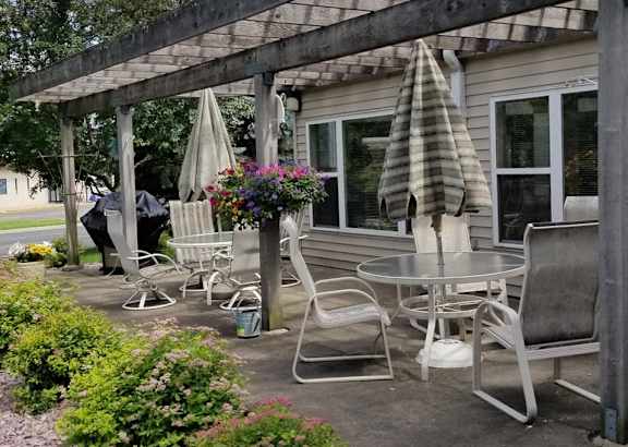a patio with chairs and tables and umbrellas