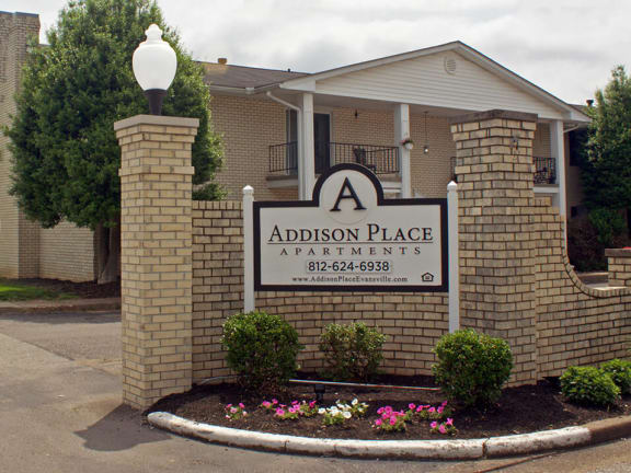 a sign that says addison place apartments