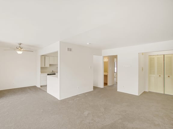 a bedroom with white walls and carpet