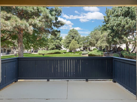 a large deck with a view of the yard and trees