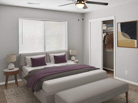 A bedroom with a large bed and a ceiling fan.