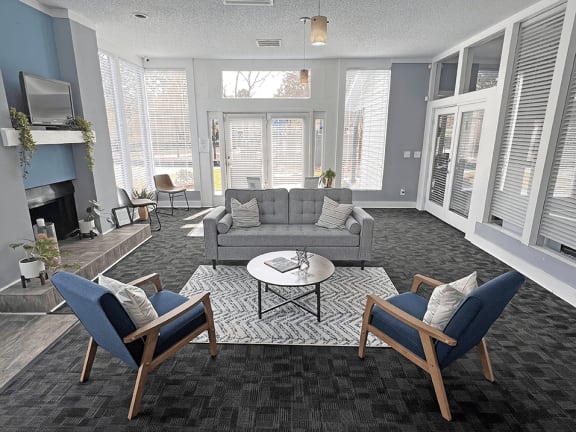 a living room with couches chairs and a coffee table