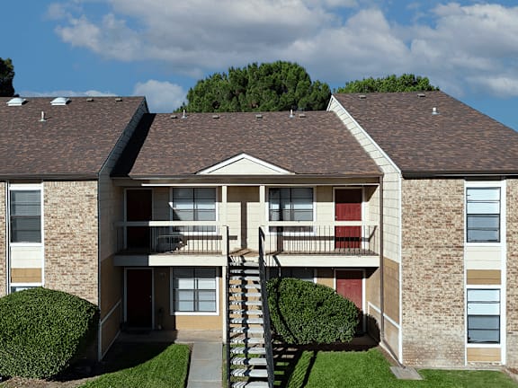 A large building with a red door and a balcony.