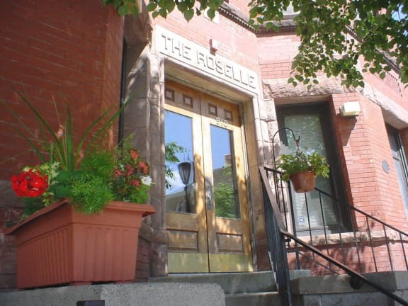 the outside of a building with a door and some plants