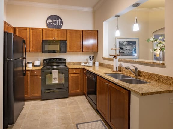 Fully-Equipped Kitchen With dishwasher, disposal, fridge, and microwave at The Bartram Apartments in Gainesville, FL