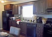 Thumbnail 4 of 11 - Fully-Equipped Kitchen at Pine Village Rental Home Community in Sanford, NC