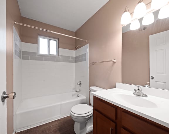 an empty bathroom with a sink toilet and shower