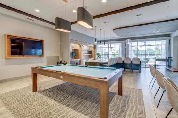 a games room with a pool table and a flat screen tv at Delamarre at Celebration, Celebration