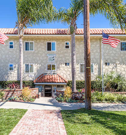 a large stone building with two american flags in front of it