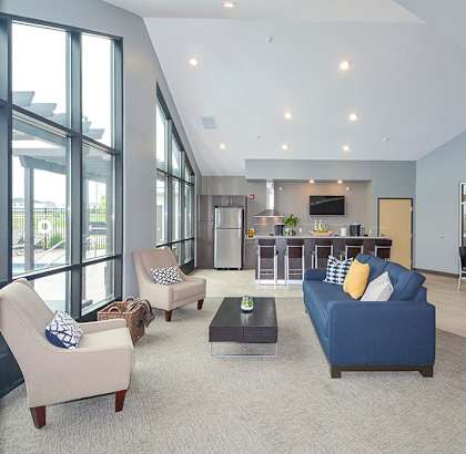 A spacious living room with a blue couch and a television.