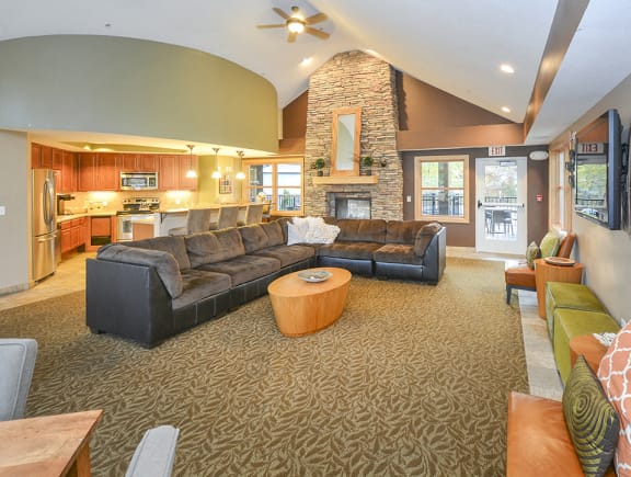 Spacious and Open Concept Clubhouse Lounge with Vaulted Ceilings, Stone Fireplace and Kitchen