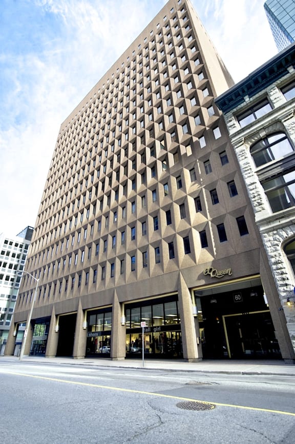 A tall building with a grid-like pattern on the side.