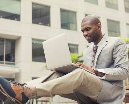 a man sitting in front of a laptop computer