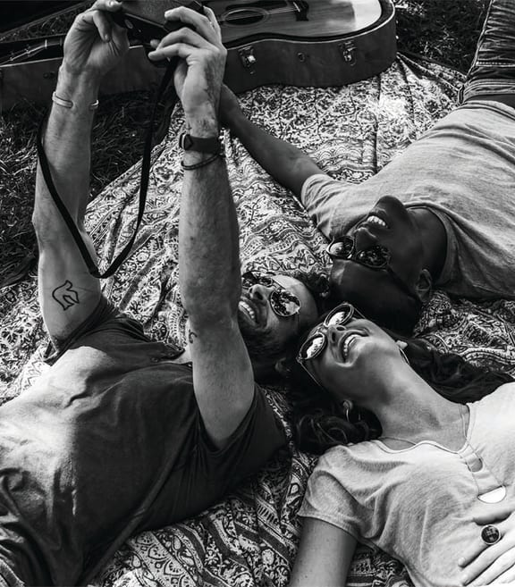 a couple of people laying on the grass