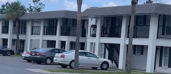 a building with two palm trees in front of it